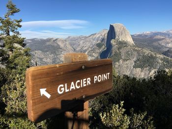 Information sign on mountain against sky