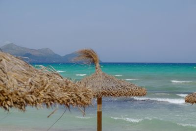 Gazebo on beach against clear sky