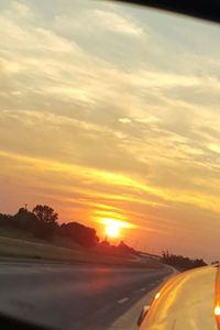 Car on road against sky during sunset