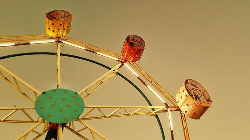 Low angle view of ferris wheel against sky