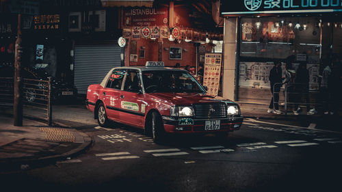 Cars on city street at night