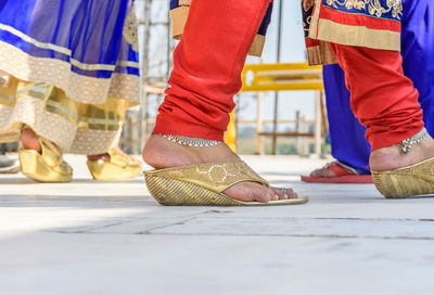 Low section of woman wearing anklets