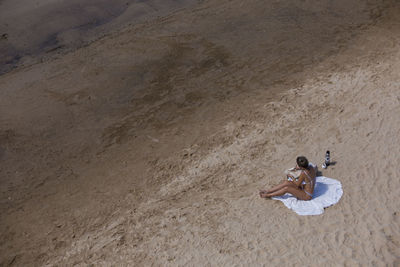 High angle view of people relaxing on beach