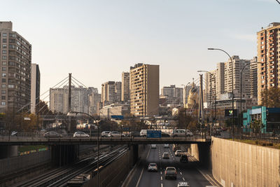 Buildings in city against clear sky