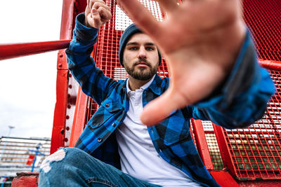 Portrait of young man sitting outdoors