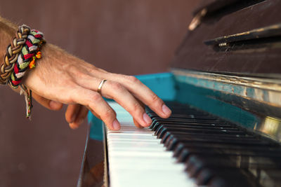 Midsection of man playing piano