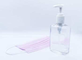 Close-up of water bottle on table against white background