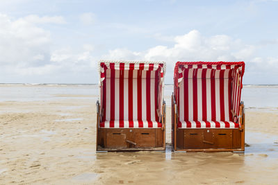 Lifeguard hut on beach against sky