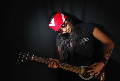 Young woman playing guitar