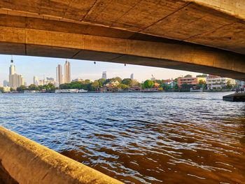 Bridge over river with city in background