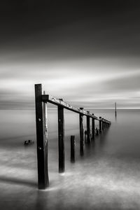 Pier over sea against sky