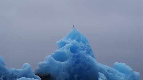 Low angle view of ice against sky