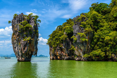 Scenic view of rocks in sea against sky