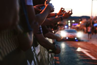 Close-up of hands photographing road event