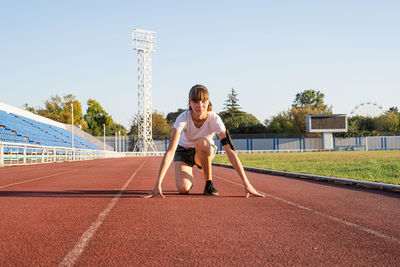 Full length of woman with on running track