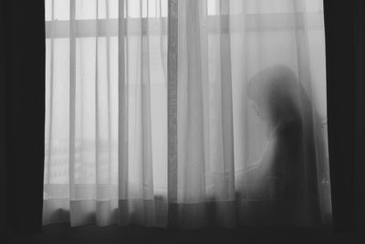 Girl sitting on window sill