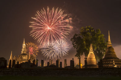 Firework display in city at night