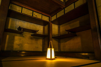 Low angle view of illuminated lights hanging on ceiling in building