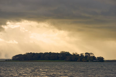 View of calm sea against cloudy sky