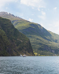 Scenic view of sea and mountains against sky