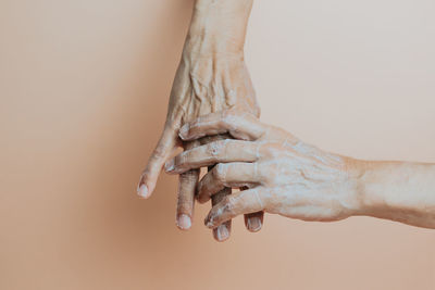 Hands of woman applying cream