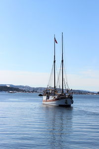 Sailboat sailing on sea against sky