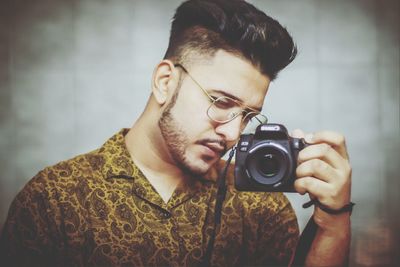 Portrait of young man photographing