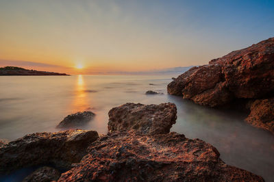 Scenic view of sea against sky during sunset