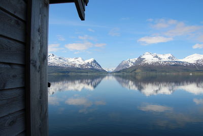 Scenic view of lake and mountains against sky during winter