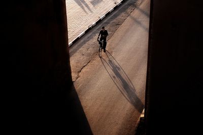 High angle view of man riding bicycle outdoors