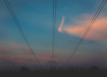 Low angle view of electricity pylon against sky