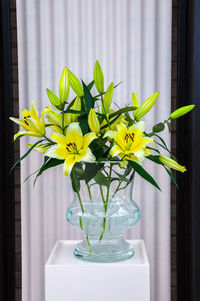 Close-up of yellow flower vase on table