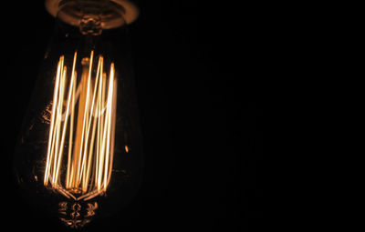 Close-up of lamp over black background