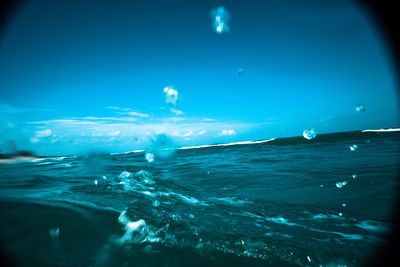 Surface level of sea against blue sky