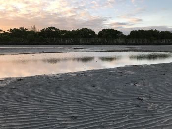 Scenic view of beach against sky during sunset