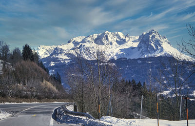 Austrian mountains covered with snow, road in front
