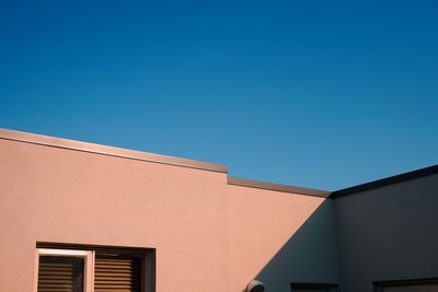 Low angle view of building against clear blue sky