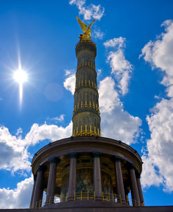 Low angle view of tower against cloudy sky