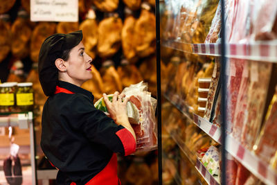 Full length of man having food in store