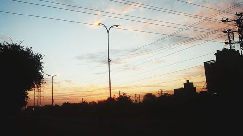 Low angle view of electricity pylon against sky