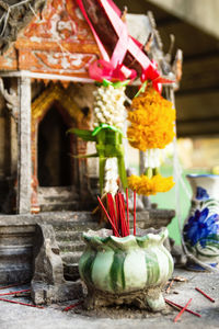 Close-up of various bell on building outside temple