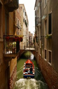 View of canal amidst buildings in city