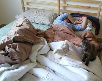 Close-up of man lying on bed at home