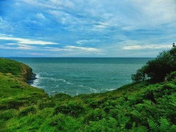 Scenic view of sea against cloudy sky