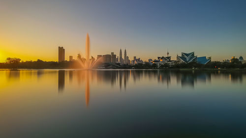 Reflection of buildings in city at waterfront