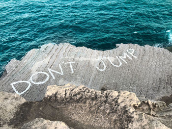 High angle view of text on rock formation