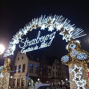 Low angle view of illuminated text on building at night