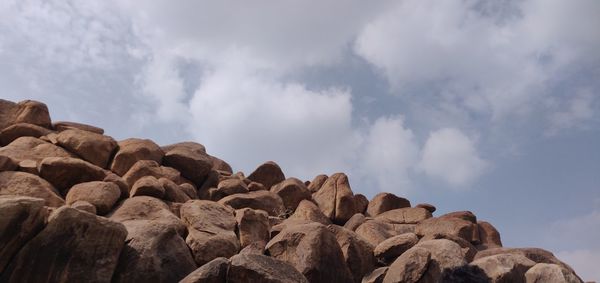Low angle view of rocks against sky