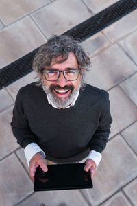 Portrait of young woman wearing hat while sitting on floor