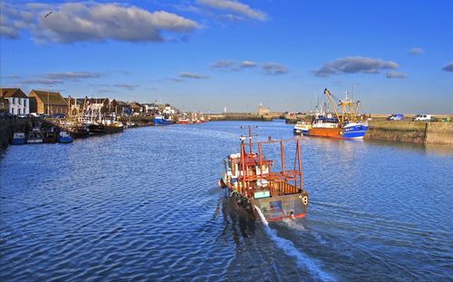 Boats moored at harbor